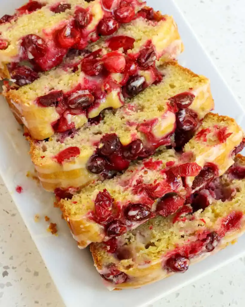 Sliced cranberry orange bread on a platter. 