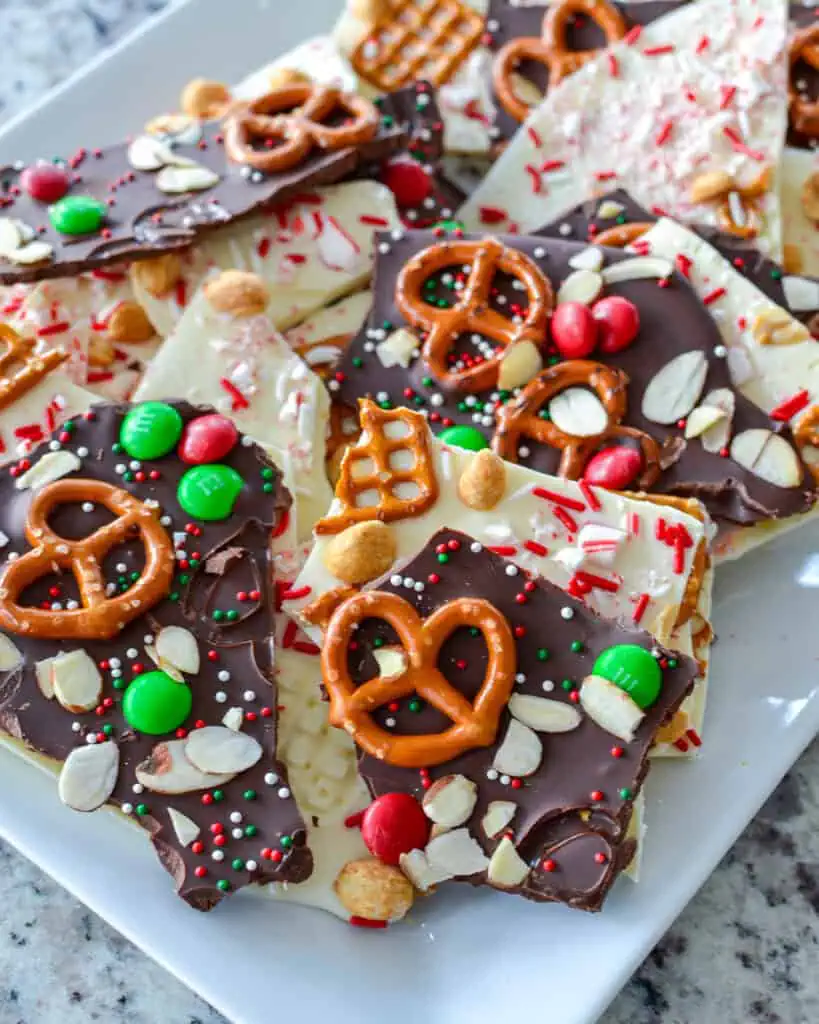 A serving platter full of white and semi-sweet chocolate Christmas bark. 