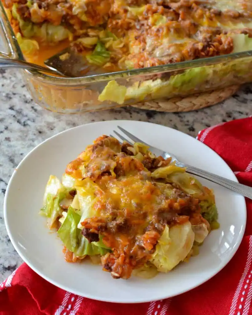 An overhead view of cabbage roll casserole on a plate with the rest of the casserole in the background. 