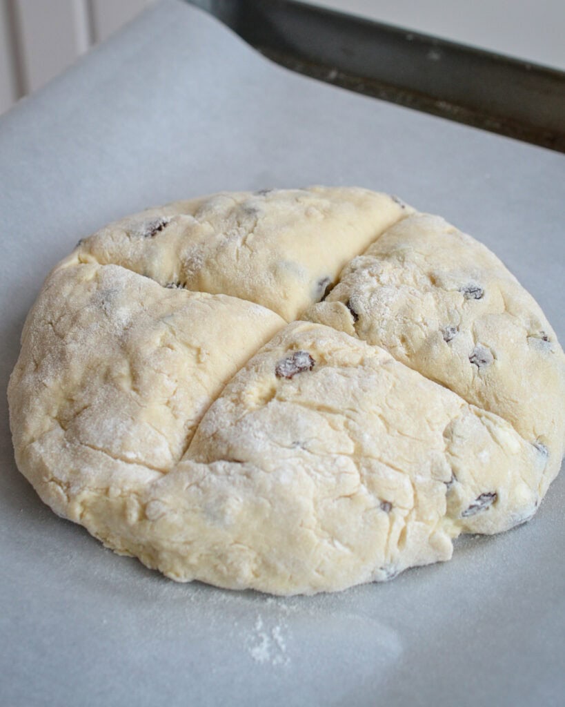 Turn the dough onto a lightly floured surface and knead until all the dough is moistened. Place it on a baking sheet covered with parchment paper or a well-seasoned cast iron skillet.