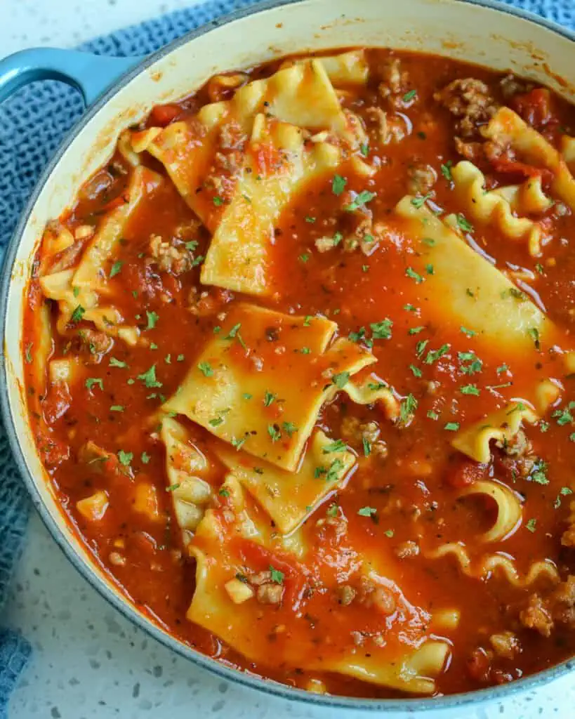 A Dutch oven full of simmered lasagna soup. 