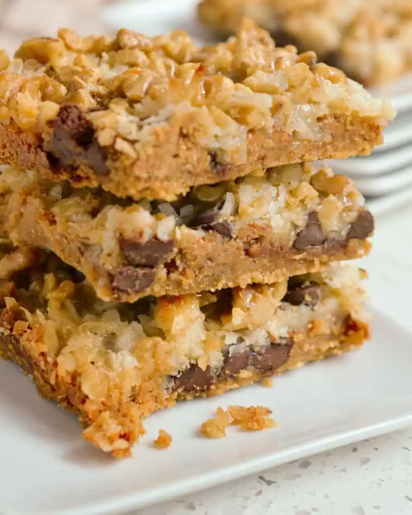 A close up view of three magic cookie bars stacked. 