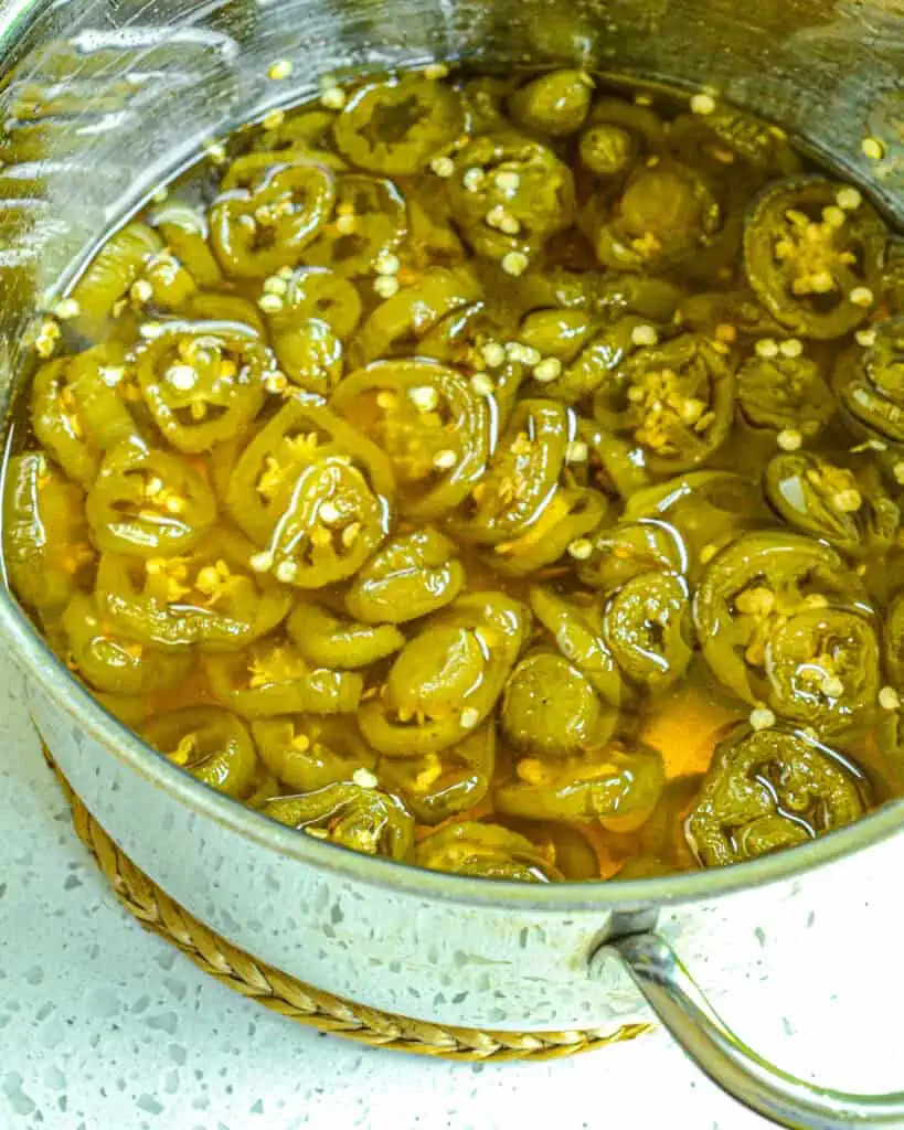 A pot full of candied jalapenos. 