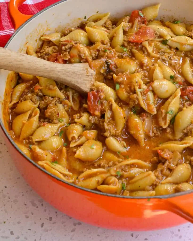 A Dutch oven full of cheesy taco pasta. 