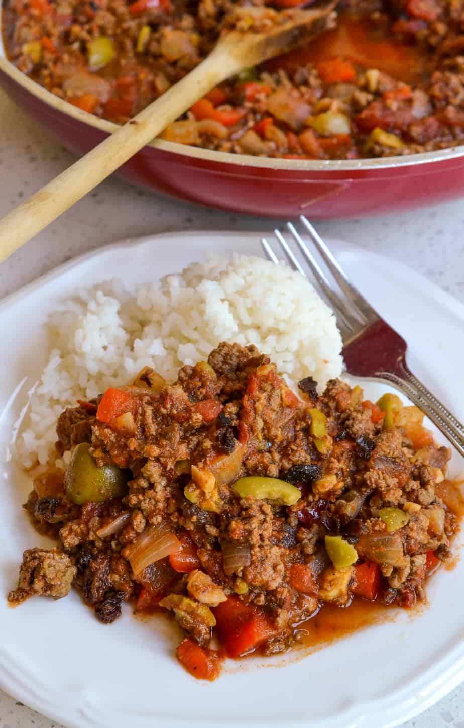 A plate full of Cuban Picadillo and white rice. 