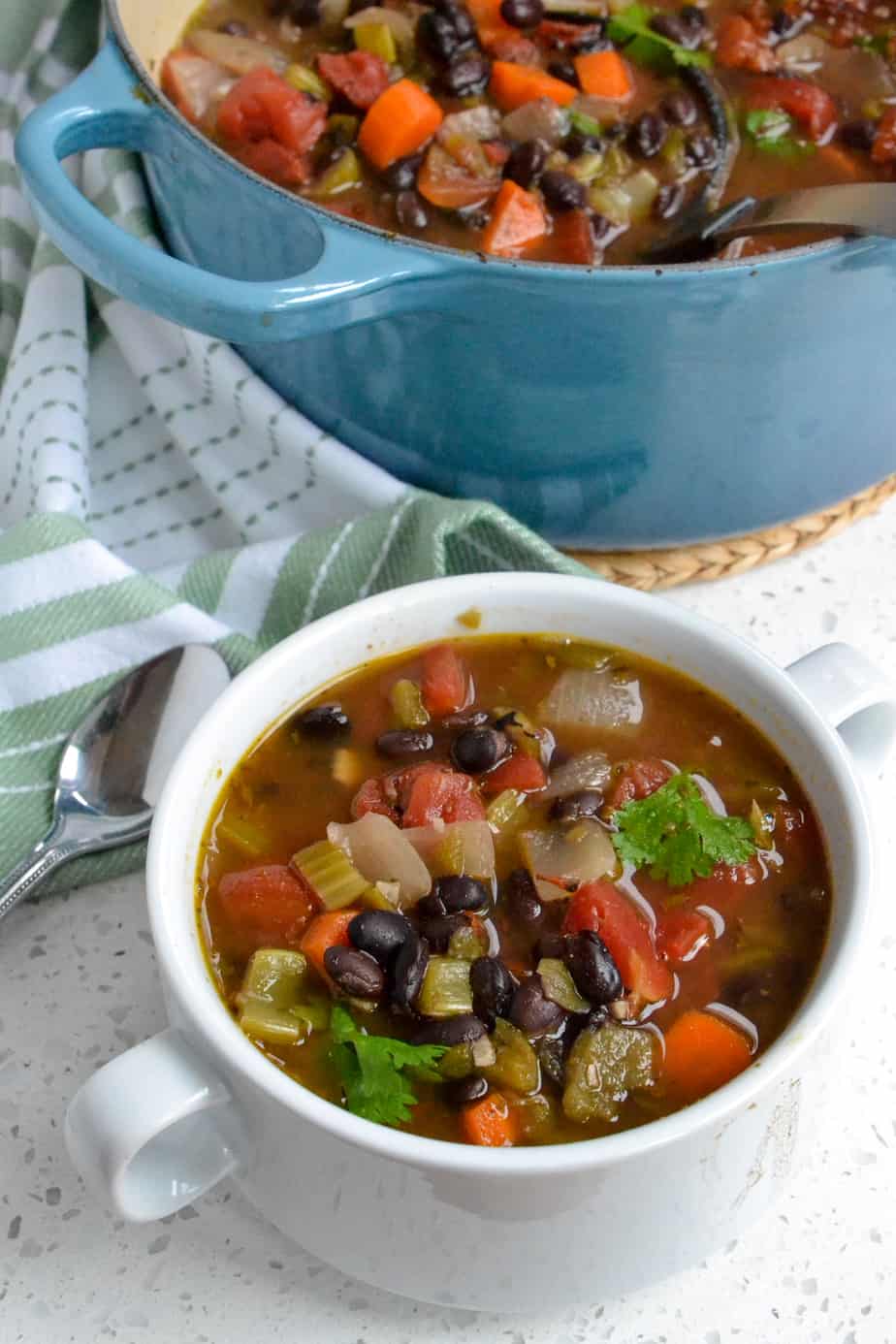 A bowl full of black bean soup. 