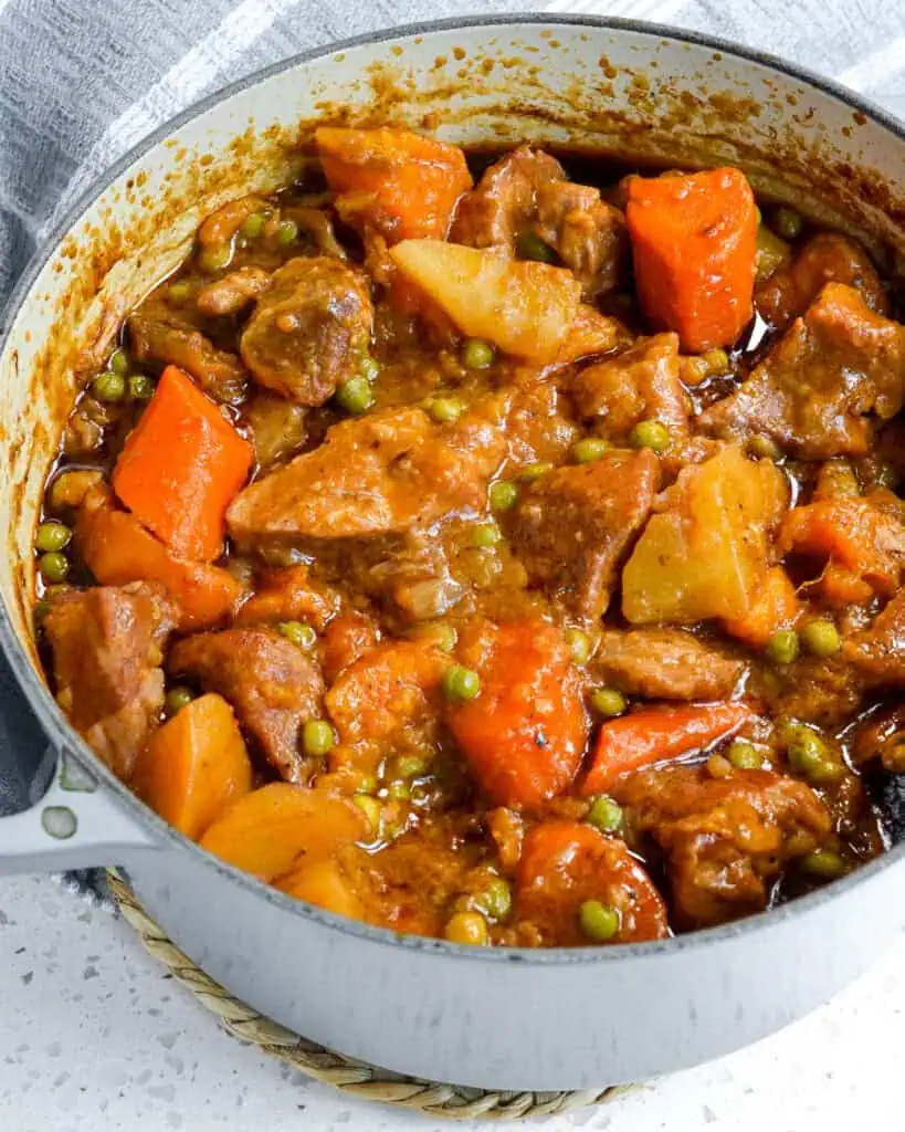 A Dutch oven full of pork stew. 