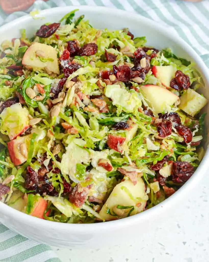 A close up view of brussels sprouts in a serving bowl. 