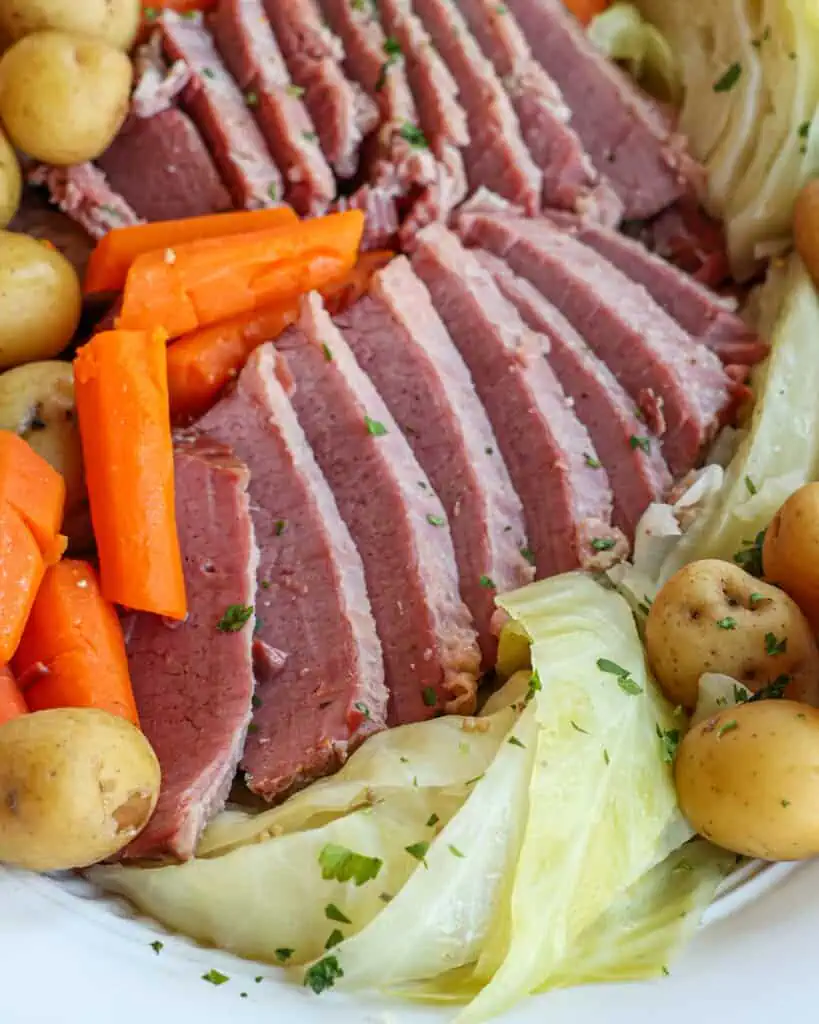 Traditional corned beef and cabbage with cabbage, potatoes, and carrots. 