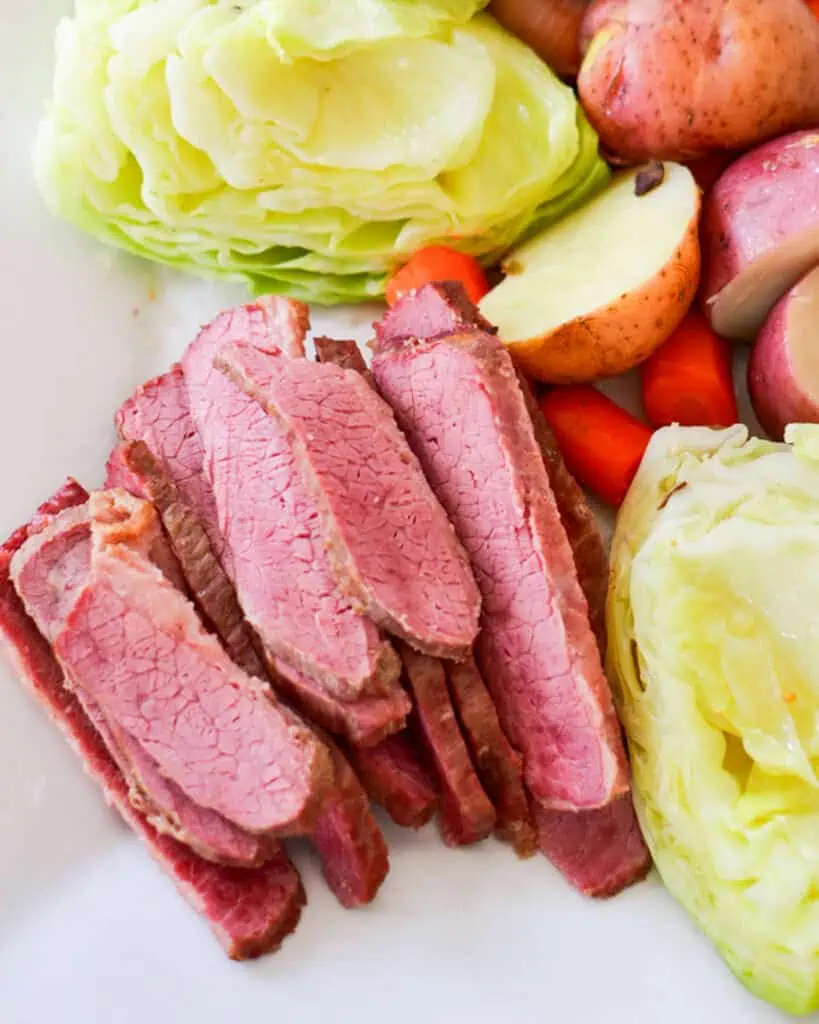 A serving plate full of corned beef, cabbage, potatoes, and carrots