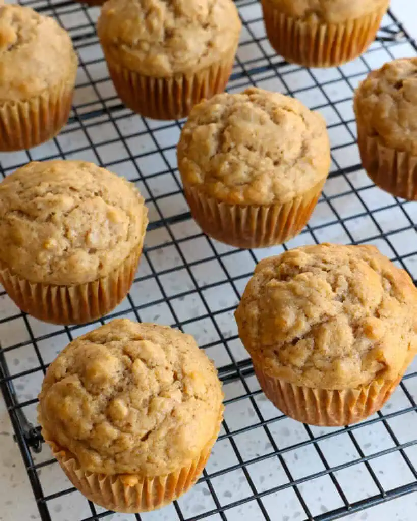 Applesauce muffins on a cooling rack. 