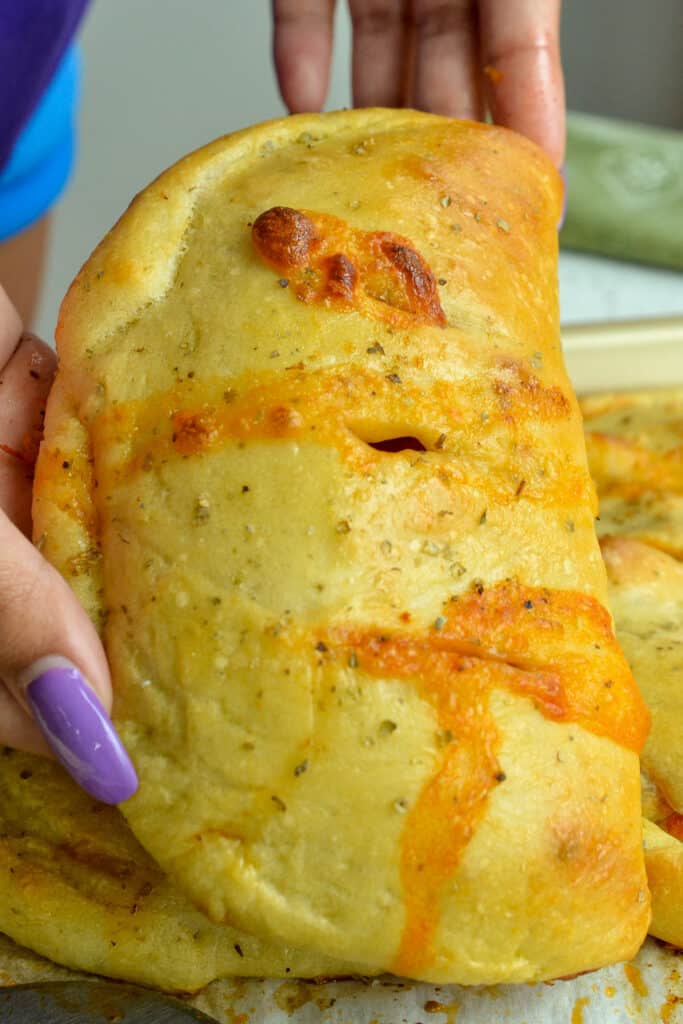 Fresh baked Pepperoni, mushroom, spinach, and onion calzone. 