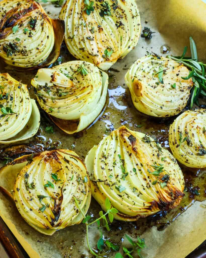 Roasted onions on a baking sheet covered with parchment paper. 