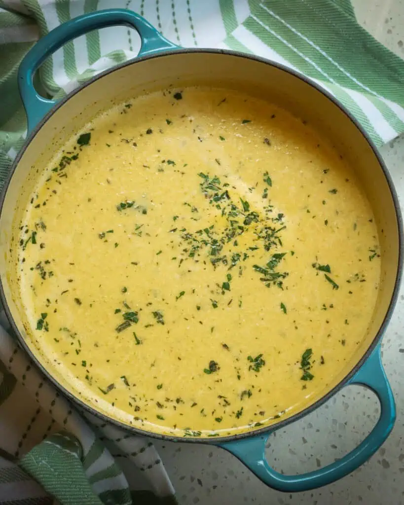 A Dutch oven full of cream of celery soup . 