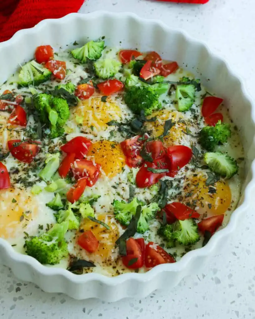 Fresh baked eggs with borccoli, tomatoes, and fr4esh herbs. 