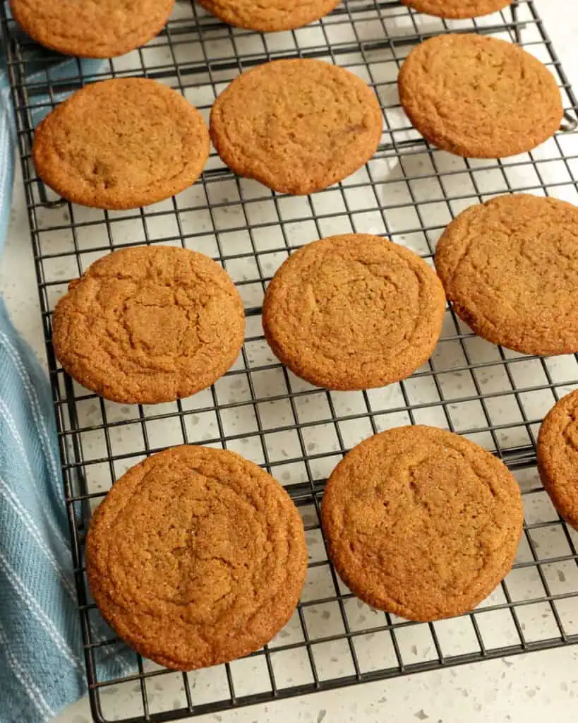 Fresh baked gingersnap cookies on a cooling rack. 