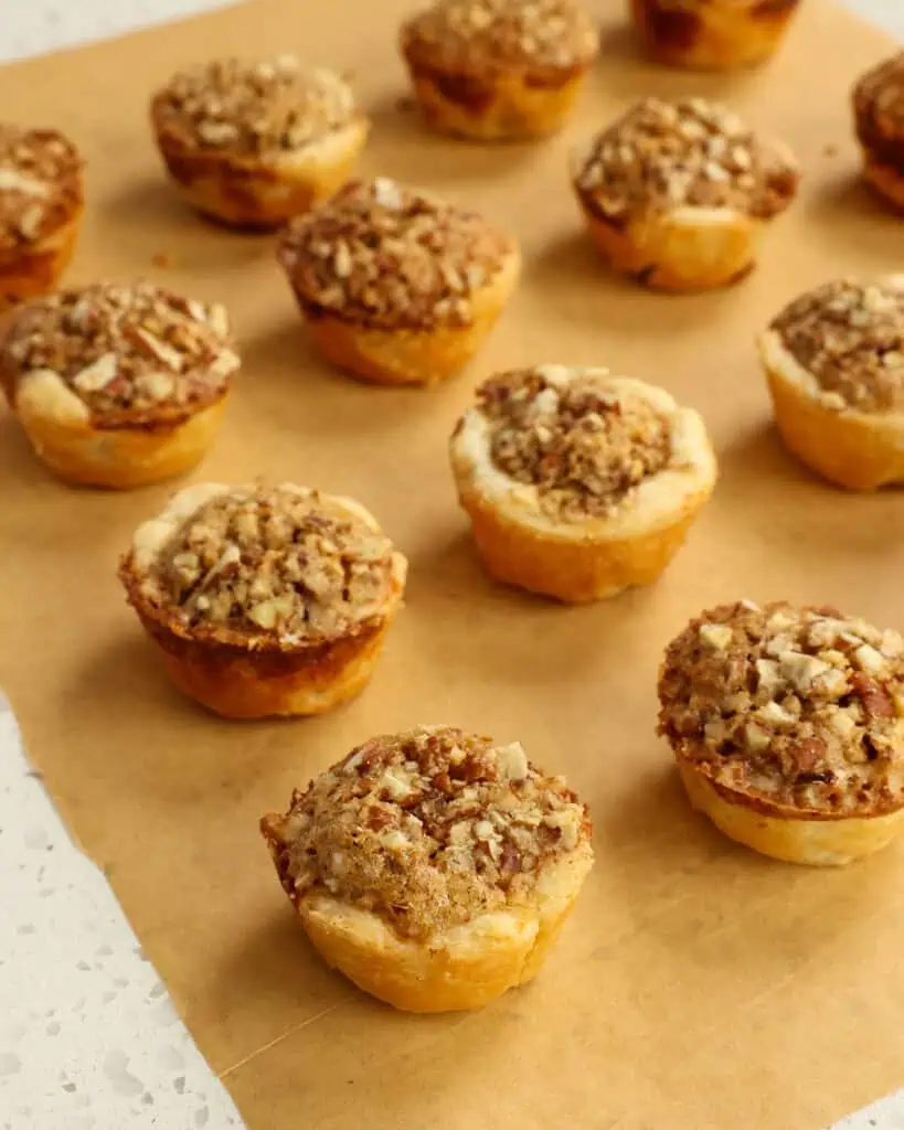 Pecan tassies on  parchment paper. 