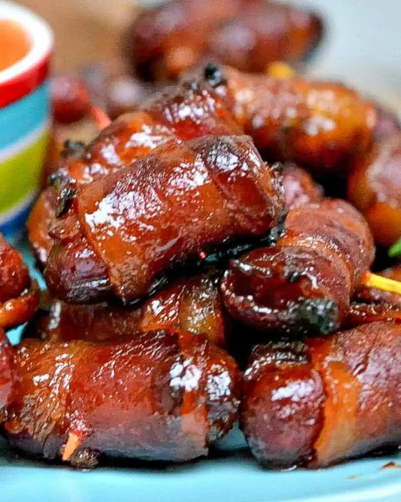 A close up view of bacon wrapped smokies. 