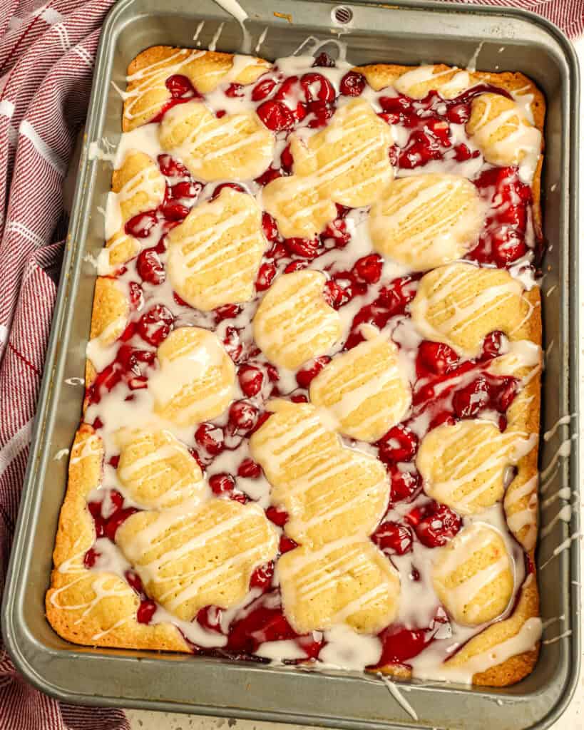 Whisk together the powdered sugar, vanilla extract, almond extract, and enough milk to reach the desired consistency in a small bowl. Drizzle over the thoroughly cooled bars.