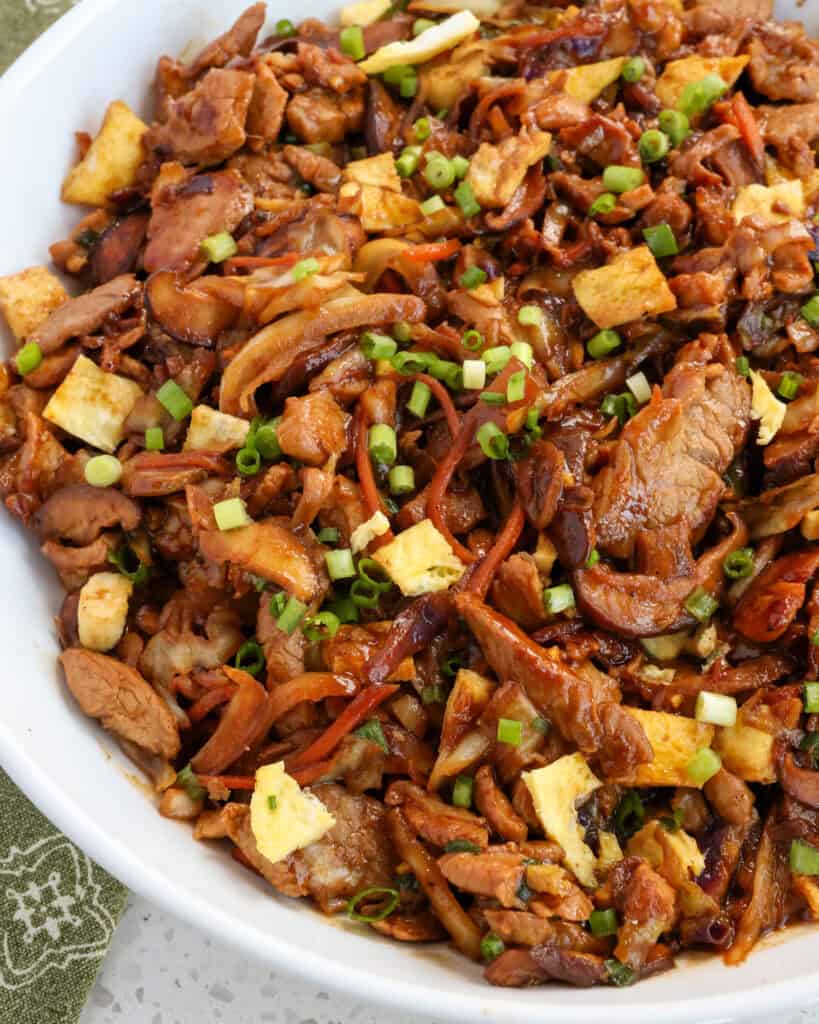 Moo Shu Pork combines marinated, thin, tender pieces of pork stir fried with cabbage, mushrooms, and eggs in a savory sauce with the flavors of garlic and ginger.