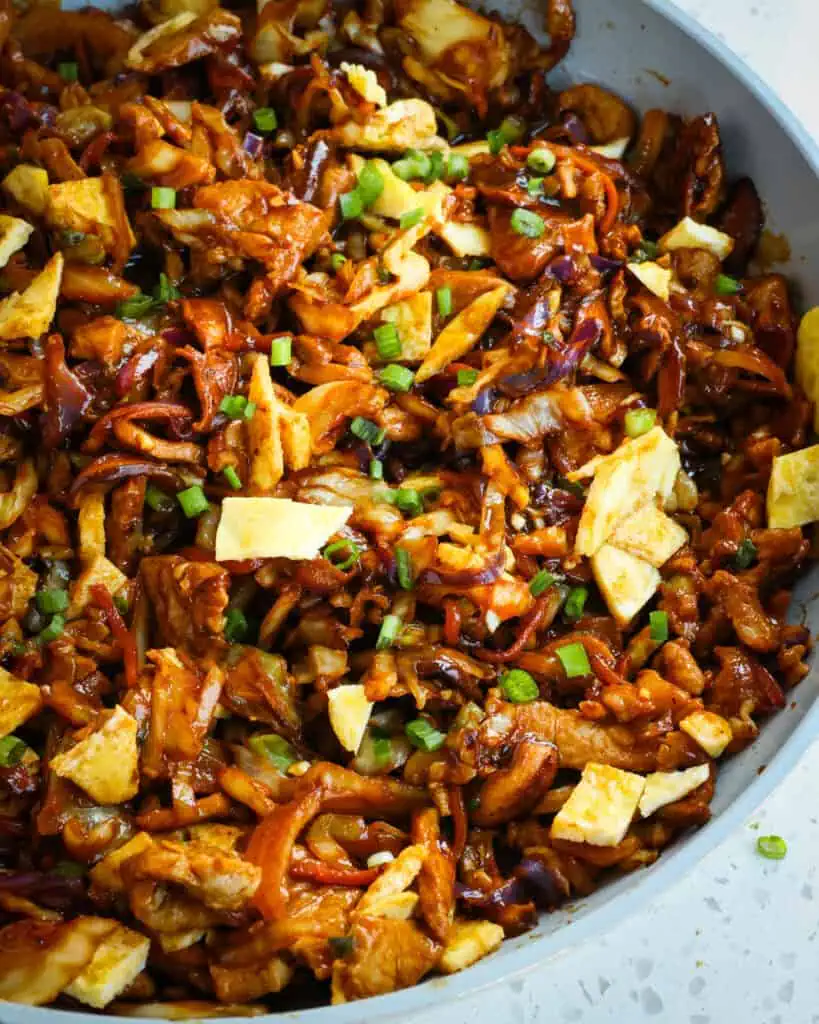 Moo Shu Pork combines thin slices of marinated pork combined with cabbage, carrots, mushrooms, eggs, and green onions in an easy savory sauce made with Hoisin, garlic, ginger, and black pepper. 