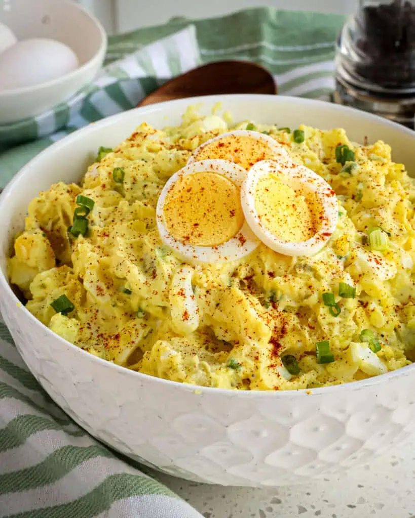 Easy southern potato salad combines potatoes, celery, green onions, pickle relish, and hard-boiled eggs, in a creamy mayonnaise-based dressing with a touch of mustard. 