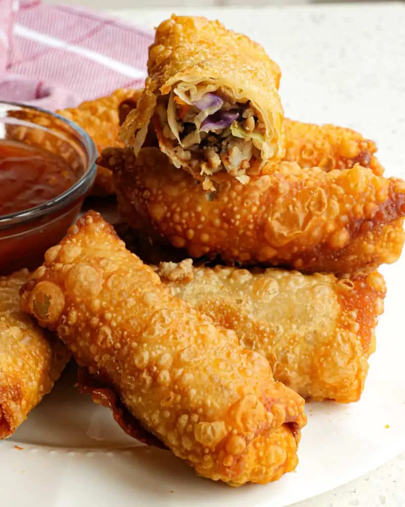 These crispy homemade Classic Egg Rolls are a cinch to make with ground pork, cabbage, carrots, and ginger, all rolled up in egg rolls wrappers and fried to golden perfection. 