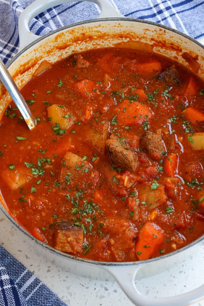 Stir in the potatoes and carrots. Bring the mixture to a boil again. Then reduce the heat and cook for about 45 minutes or until the vegetables and beef are fork tender.