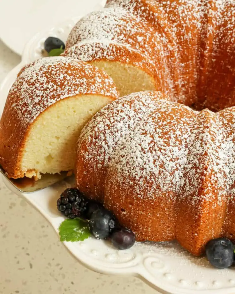 A slice of cream cheese pound cake cut from the cake on a cake server. 