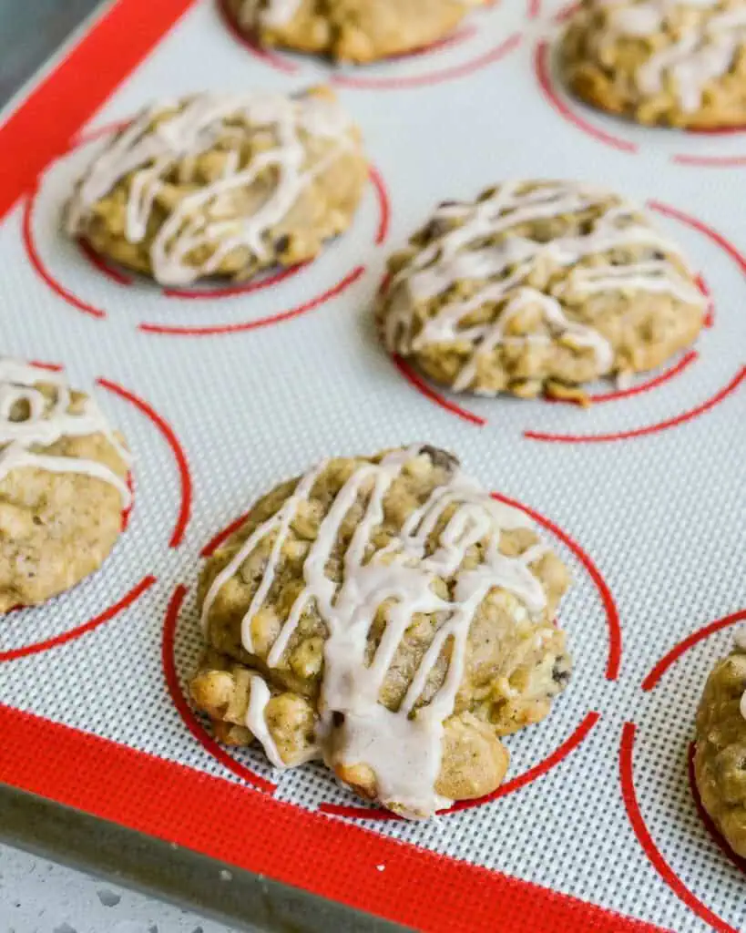 Apple cookies on a silicone baking mat. 