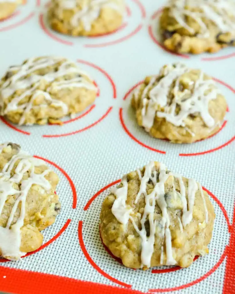 Fresh baked apple cookies on a silicone mat. 