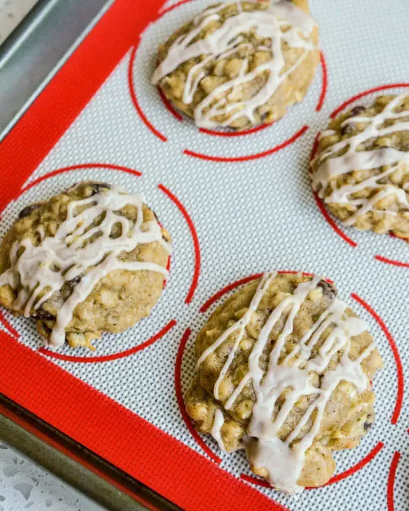 An overhead view of apple cookies drizzled with cinnamon glaze. 