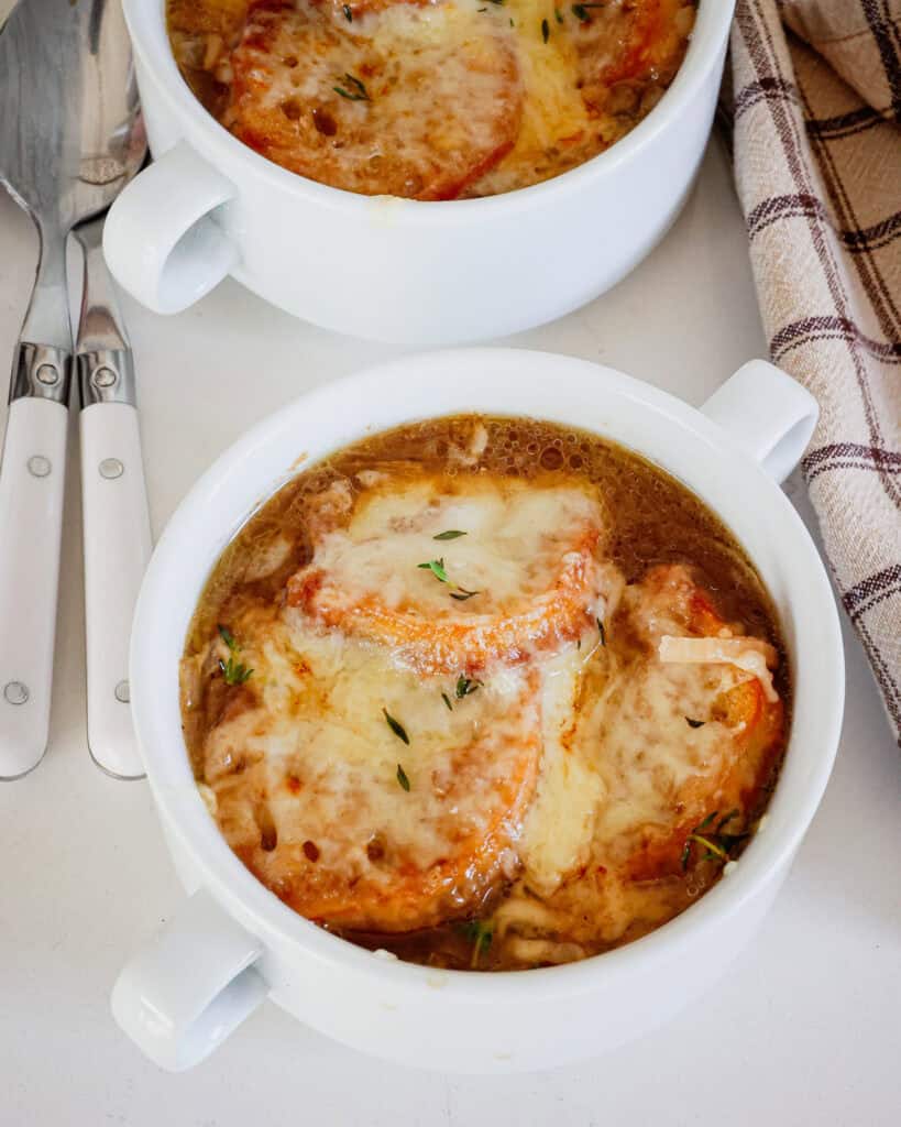 Classic French Onion Soup with slow-cooked caramelized sweet onions, crisp baked crostini, and plenty of smooth melting Gruyère Cheese.