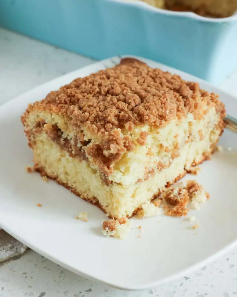 A single serving plate with a piece of sour cream coffee cake on it. 