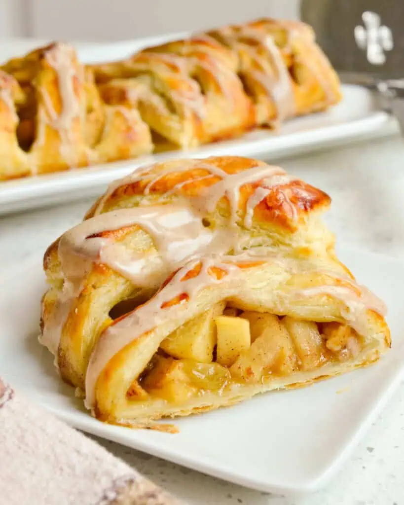 A slice of apple strudel on a single serving plate. 