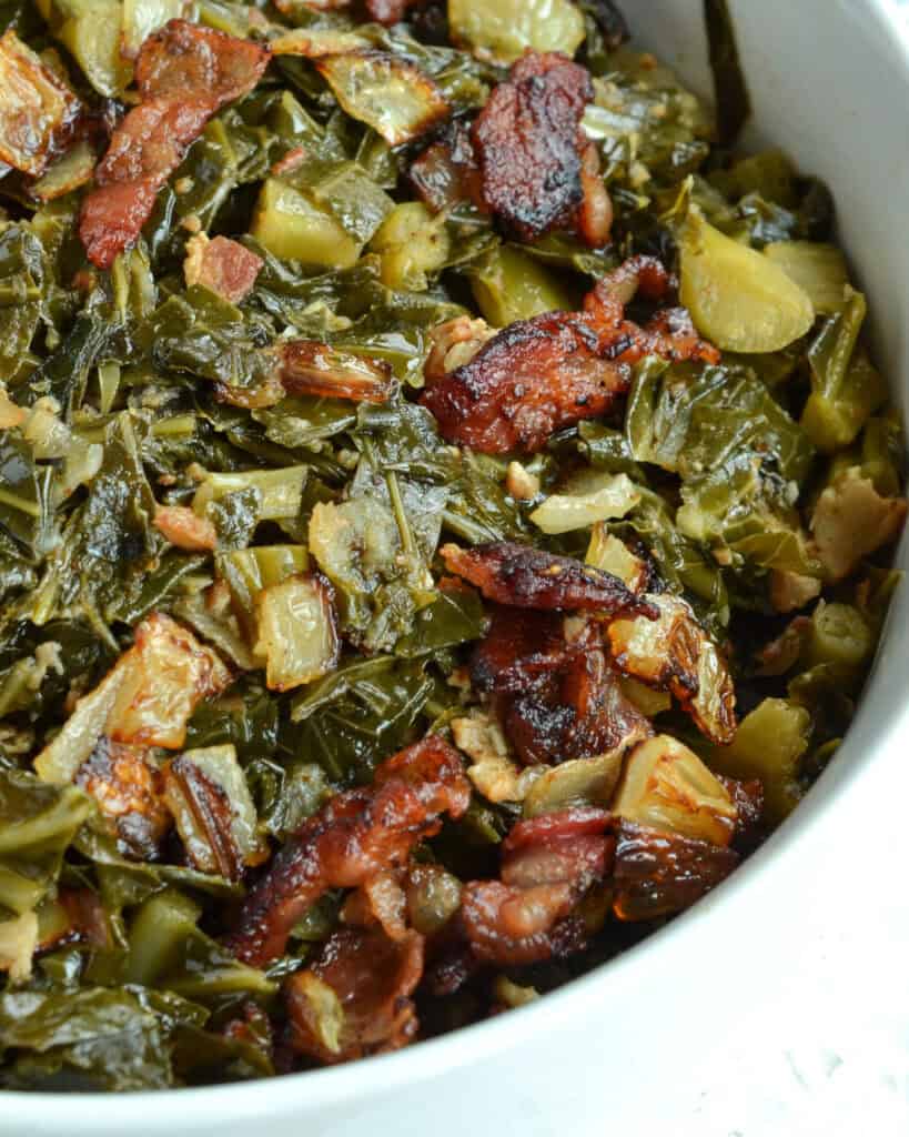 A close up view of collard greens in a bowl. 