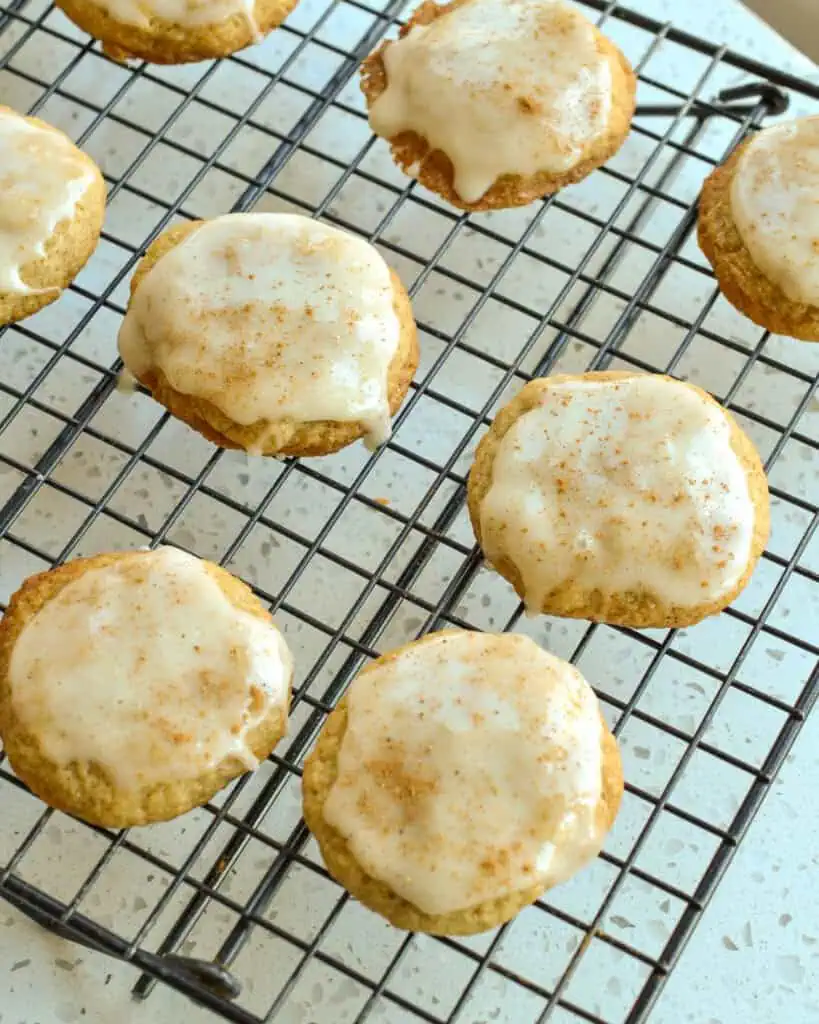 Glazed eggnog cookies on a cooing rack. 