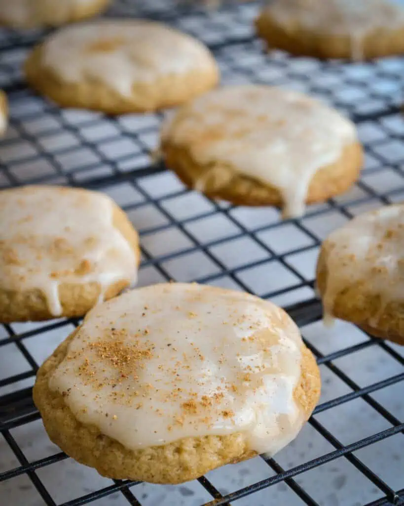 Glazed eggnog cookies on a cooling rack. 