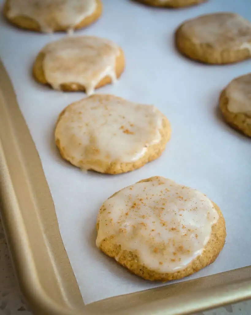 Homemade eggnog cookies on a baking sheet with parchment paper. 