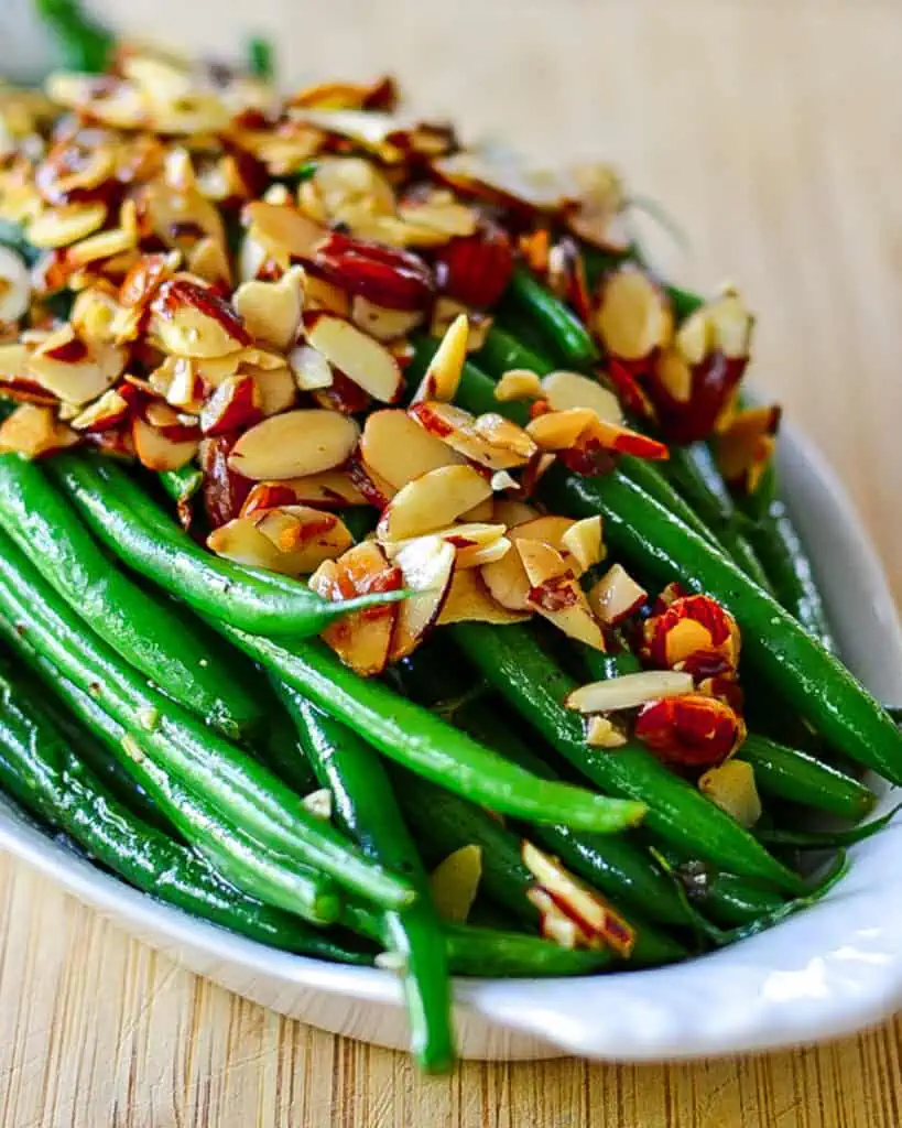 Green beans almondine in a casserole dish. 