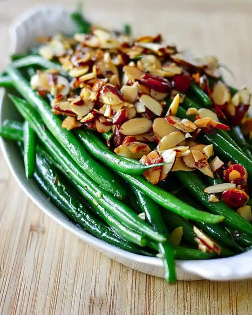 This quick and easy Green Beans Almondine Recipe combines French green beans with toasted almonds, garlic, and little lemon juice for an elegant side dish.