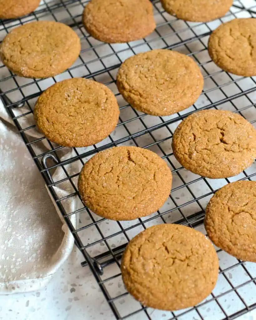 Freshly baked molasess cookies cooling on a wire rack. 