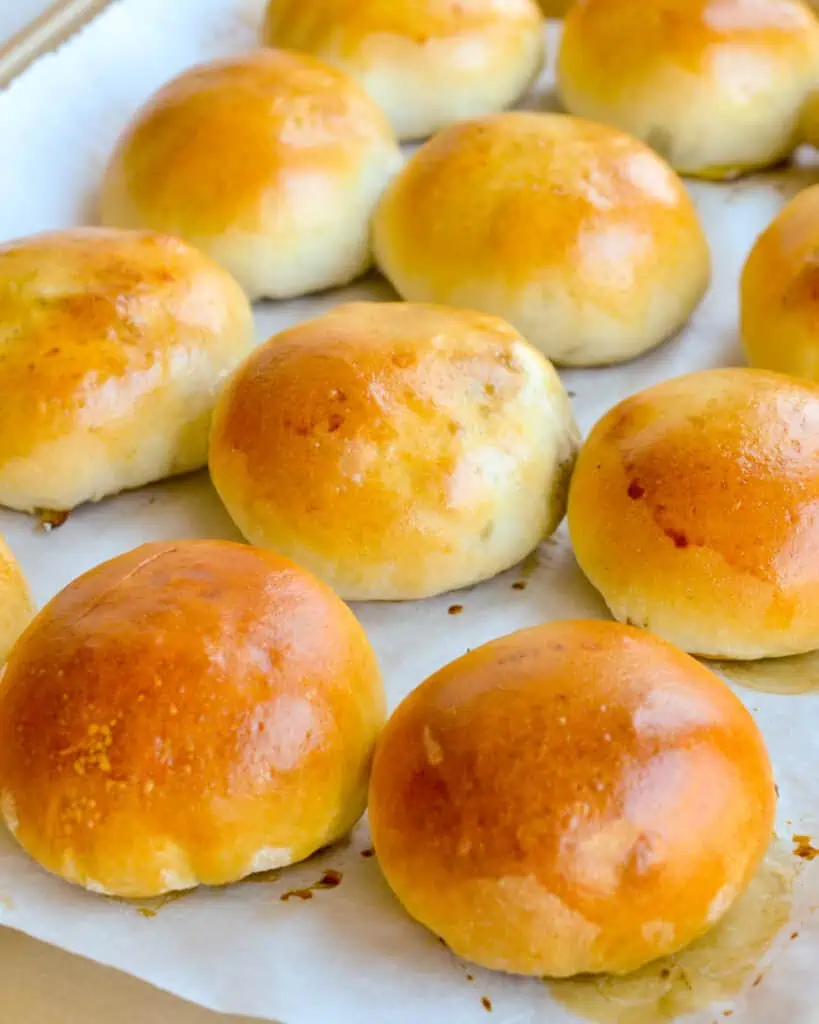 Perfectly browned runzas on a parchment paper covered baking sheet. 