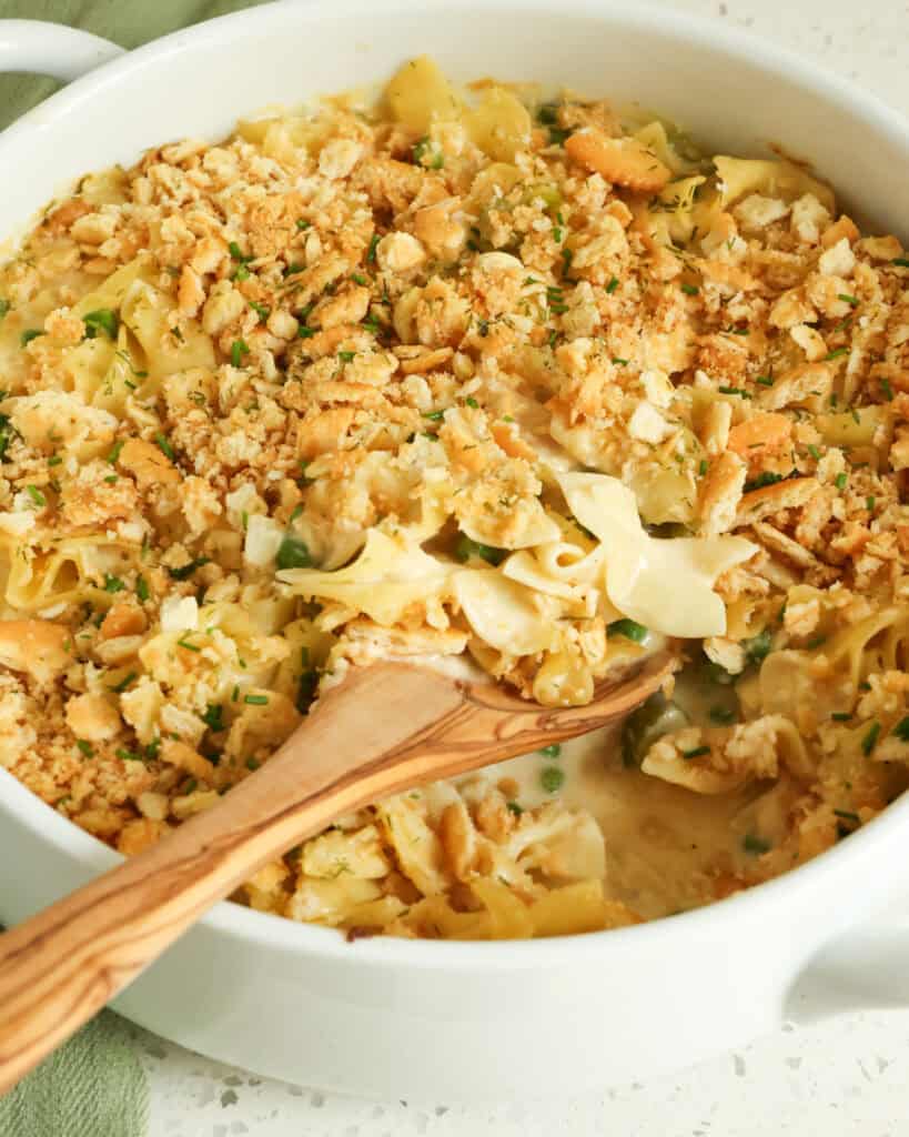 A large round casserole dish full of classic tuna noodle casserole. 