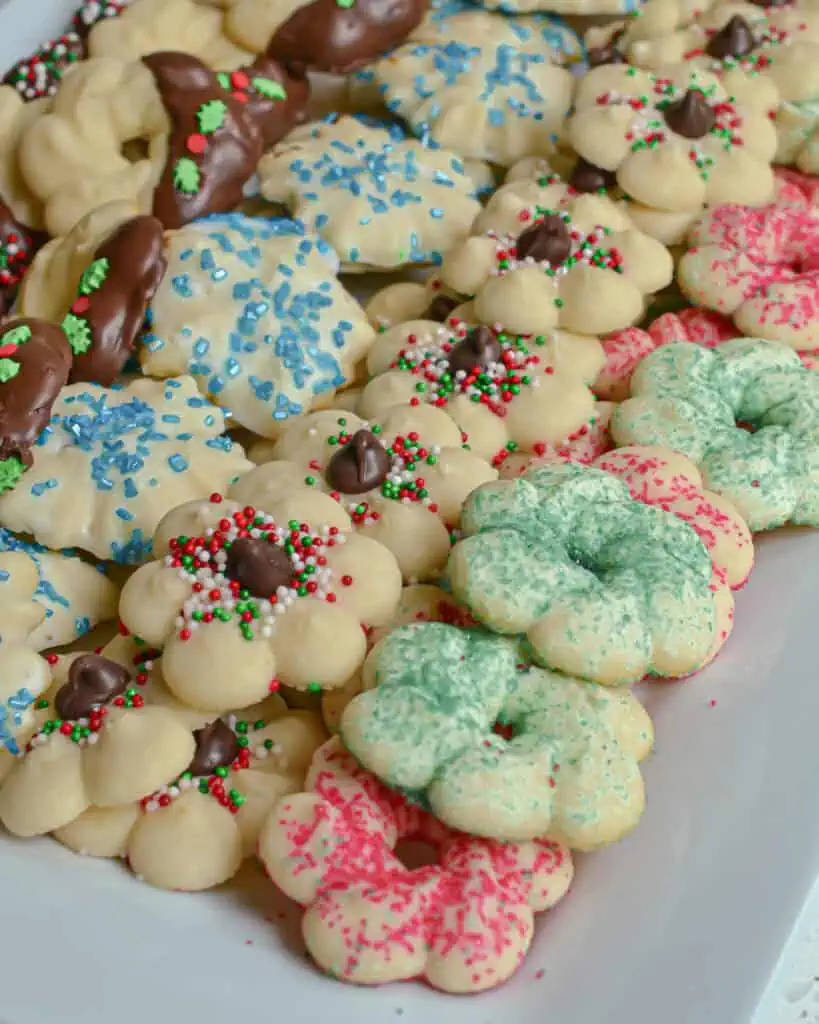 Spritz Cookies are tiny cookies that are similar to butter cookies and sugar cookies. They are formed using a cookie press.  