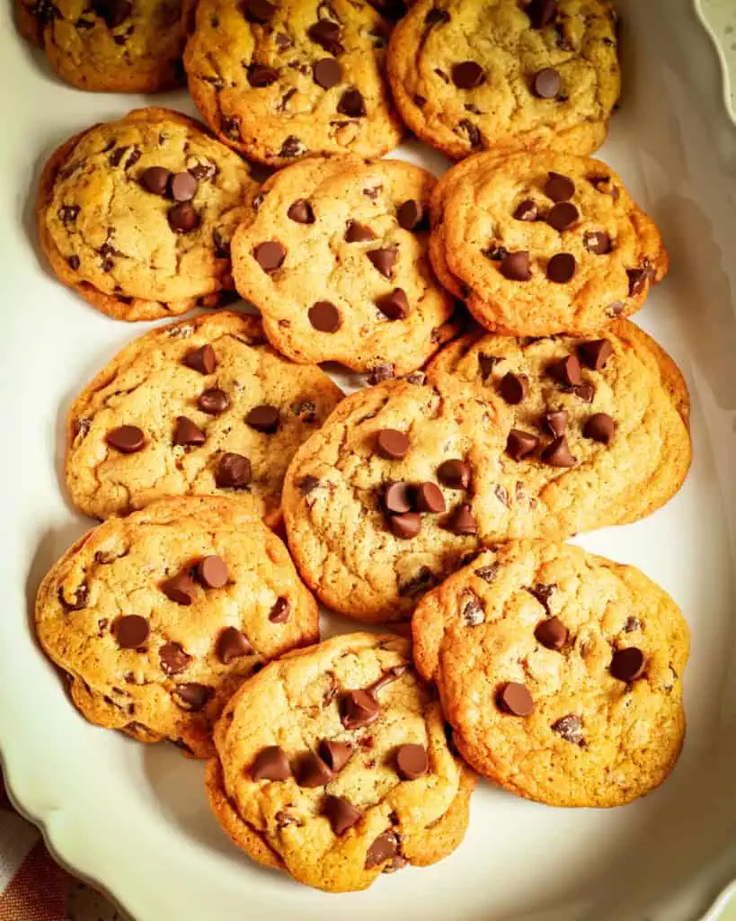 Chewy chocolate chip cookies on a large white platter. 