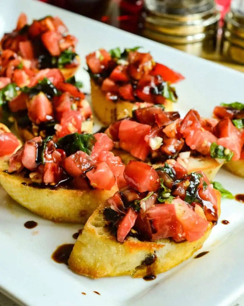 Bruschetta on freshly toasted baquette slices with a balsamic drizzle. 