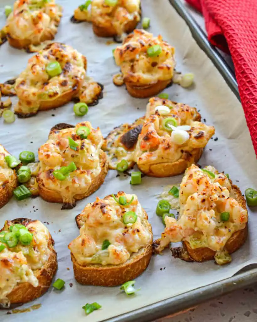 Shrimp toasts are fresh chopped shrimp, onion, celery, and garlic, all nested in a luscious sauce made from cream cheese, Parmesan, and Fontina cheese with just a hint of Cajun spice.