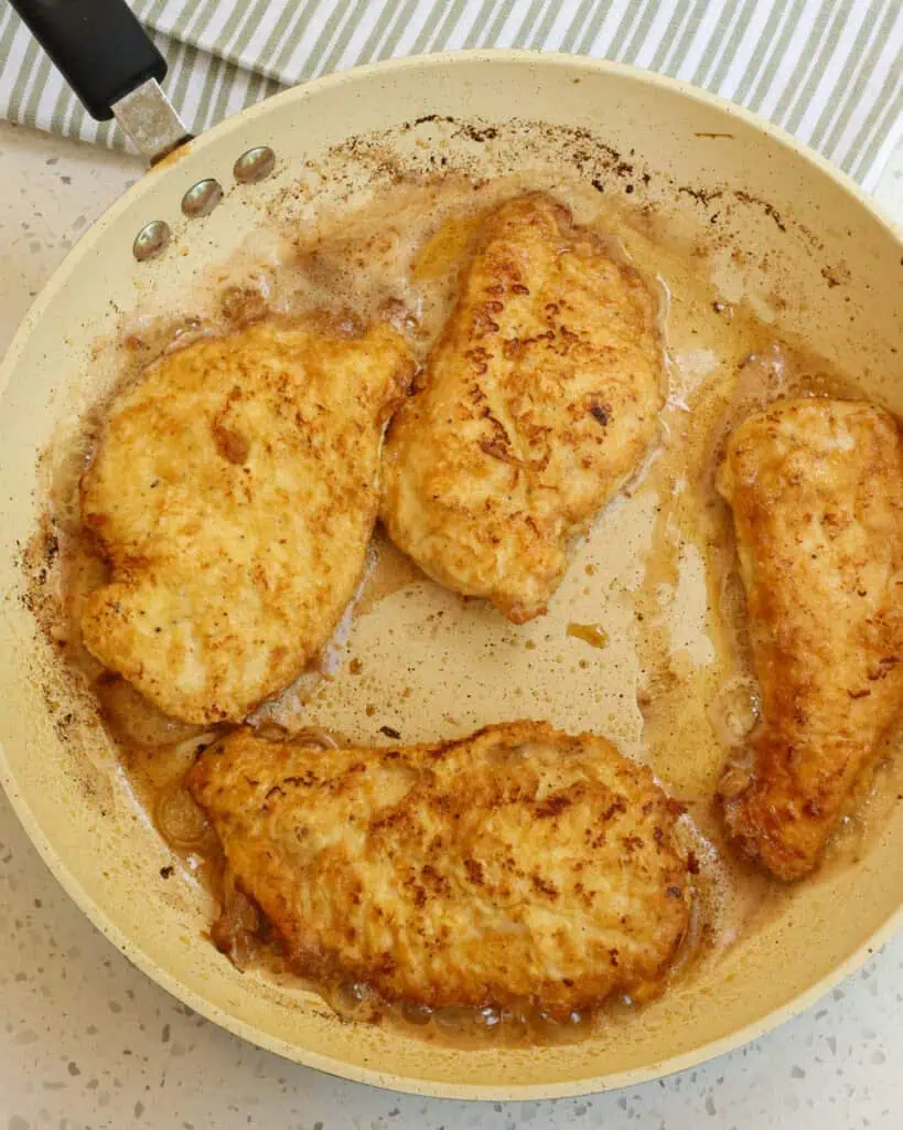 Add the chicken to the skillet and fry until golden brown on the bottom. Then, flip and fry until golden brown on the other side and cooked through