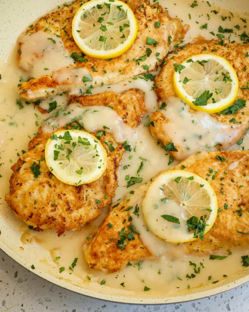 Easy Chicken Frances is chicken breaded in first flour and then eggs pan fried and served in a white wine lemon sauce with fresh lemons and chopped Italian parsley.